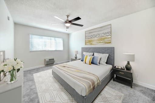 a bedroom with a large bed and a ceiling fan
