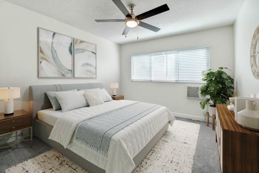 a bedroom with a bed and a ceiling fan