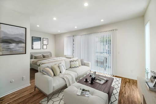 a living room with two beds and a couch and a table
