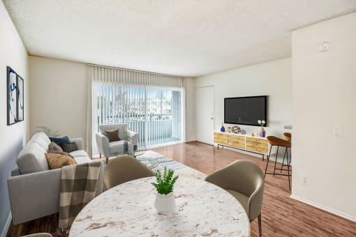 a living room with a round table and a couch and a tv