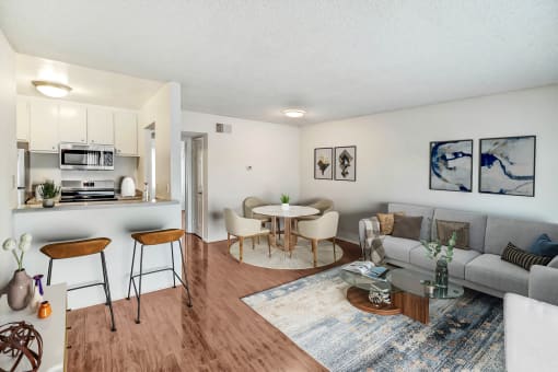 a living room and kitchen with a couch and a table