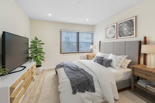 a bedroom with a bed and a tv
