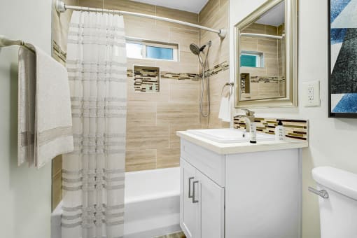 a small bathroom with a shower and a sink and a mirror