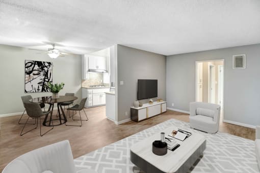 an open living room and dining room with a table and chairs