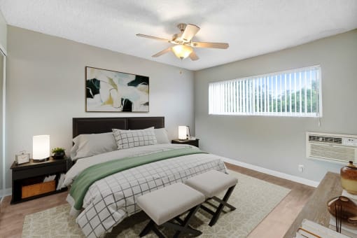 a bedroom with a large bed and a ceiling fan