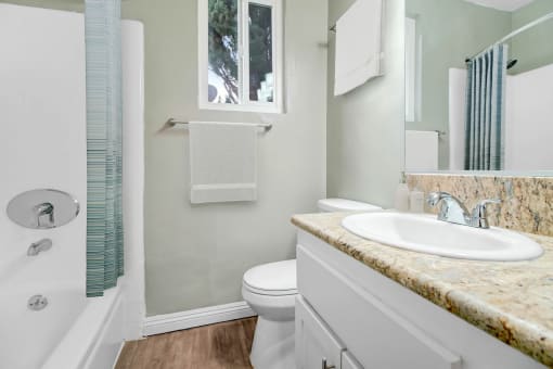 a bathroom with a sink toilet and a shower