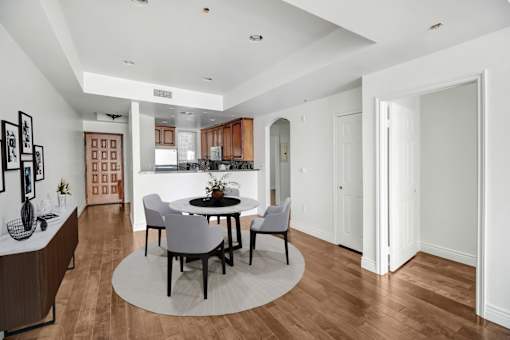 a dining room with a table and chairs and a kitchen