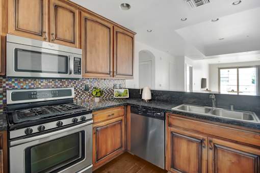 a kitchen with stainless steel appliances and wooden cabinets