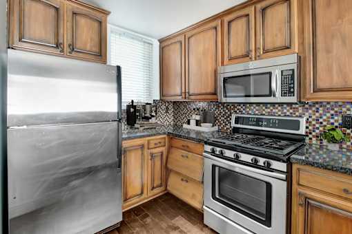 a kitchen with stainless steel appliances and wooden cabinets