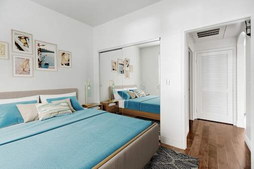 a bedroom with two beds and a mirror