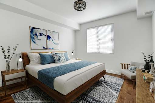 a bedroom with a white bed and a blue blanket