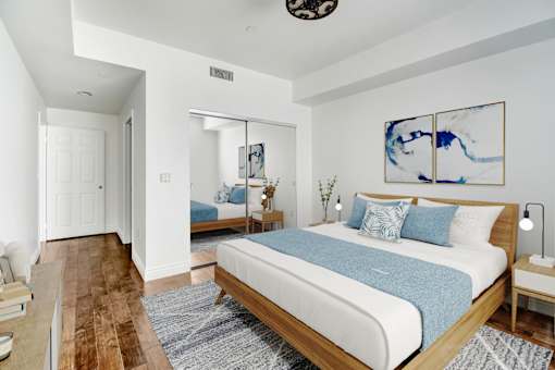 a bedroom with a large bed and a mirror