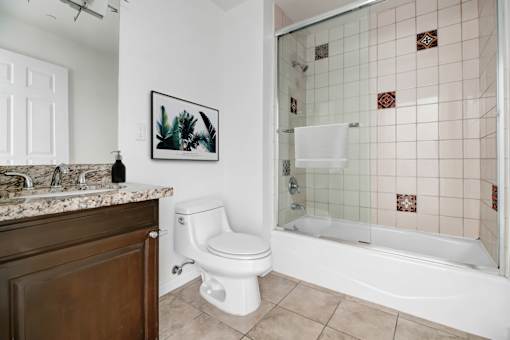 a bathroom with a tub and a toilet and a sink