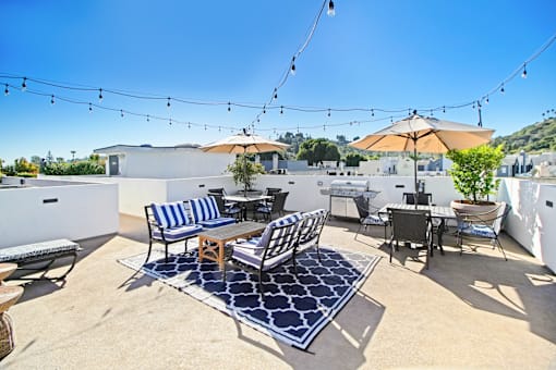 a patio with chairs and tables and umbrellas