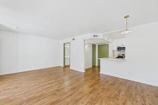 A room with wooden floors and white walls.