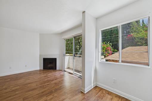 A room with a fireplace and a sliding glass door.