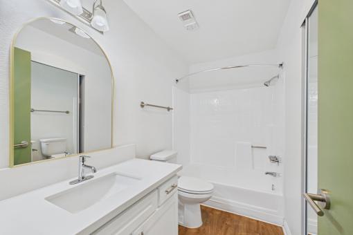 A bathroom with a sink, toilet, and bathtub.