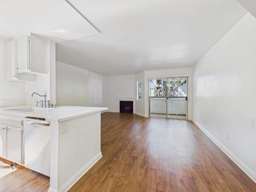 A kitchen with white cabinets and a white sink.