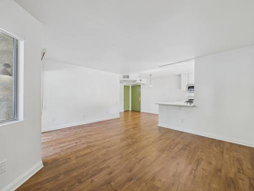 A room with wooden floors and white walls.