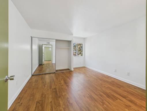 A room with wooden floors and a white ceiling.