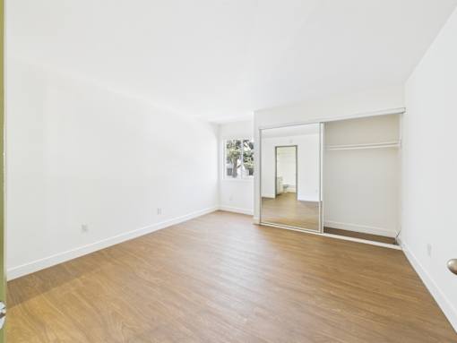 A room with a wooden floor and white walls.