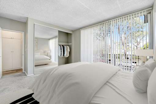 A bedroom with a large bed and a wardrobe.