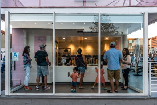 a group of people standing in front of a window