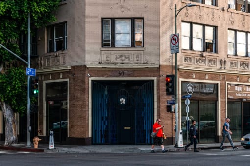 people crossing the street in front of a building
