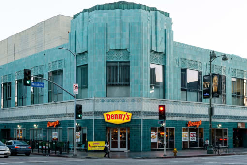 a large blue building with a domed top on the corner of a street