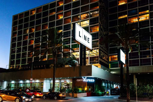 a city street with a large lit up sign in front of a building