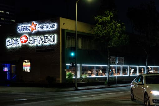a restaurant with a lit up sign on the side of a building