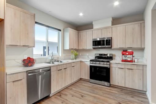 a kitchen with wooden cabinets and stainless steel appliances