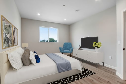 a bedroom with a bed and a tv in a room