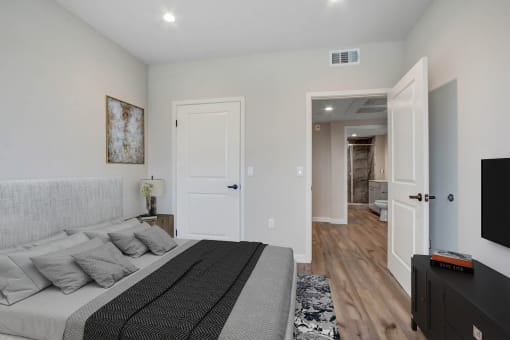 a bedroom with a large bed and a tv