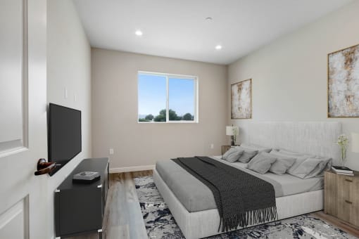 a bedroom with a large bed in front of a window