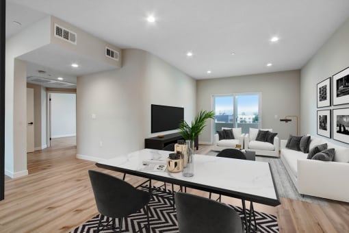 a living room with white walls and hardwood floors