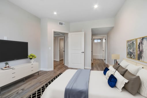 a bedroom with a large bed and a tv