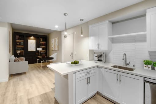 a kitchen with white cabinets and a white counter top