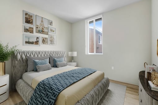 a bedroom with a bed and pictures on the wall