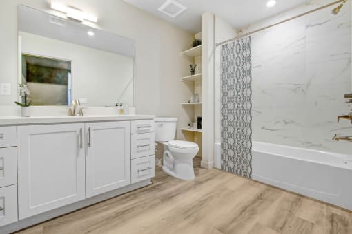 a bathroom with a toilet and a shower and a sink