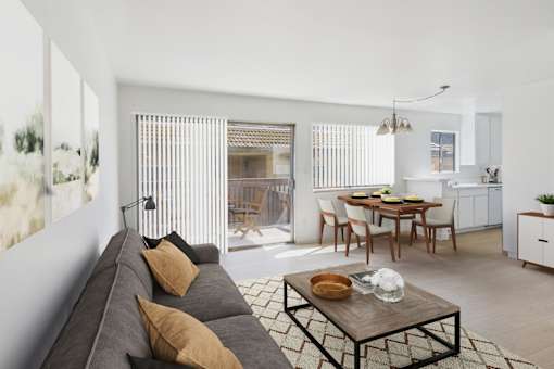 A living room with a grey couch and a wooden coffee table.