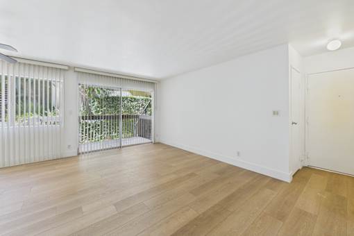 A room with wooden floors and white walls.