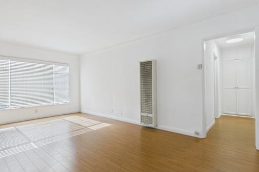 A room with a white wall and a white door.