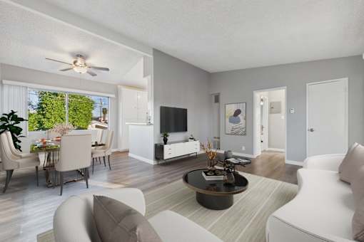 A modern living room with a white sofa and a coffee table.