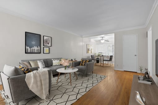a living room with a couch and a chair and a dining room table