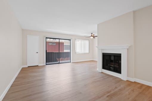 a living room with hardwood floors and a fireplace