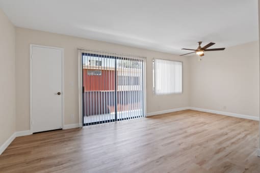 a bedroom with hardwood floors and a ceiling fan