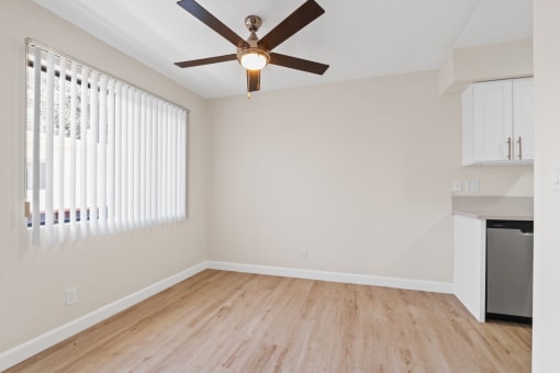 a bedroom with hardwood floors and a ceiling fan