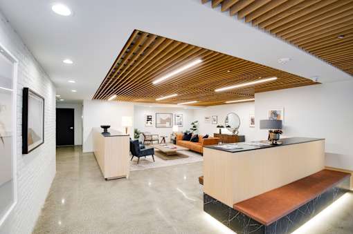 A reception area with a wooden ceiling and a white wall.