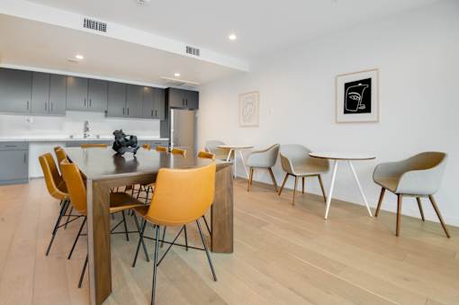A modern dining room with a table and chairs.